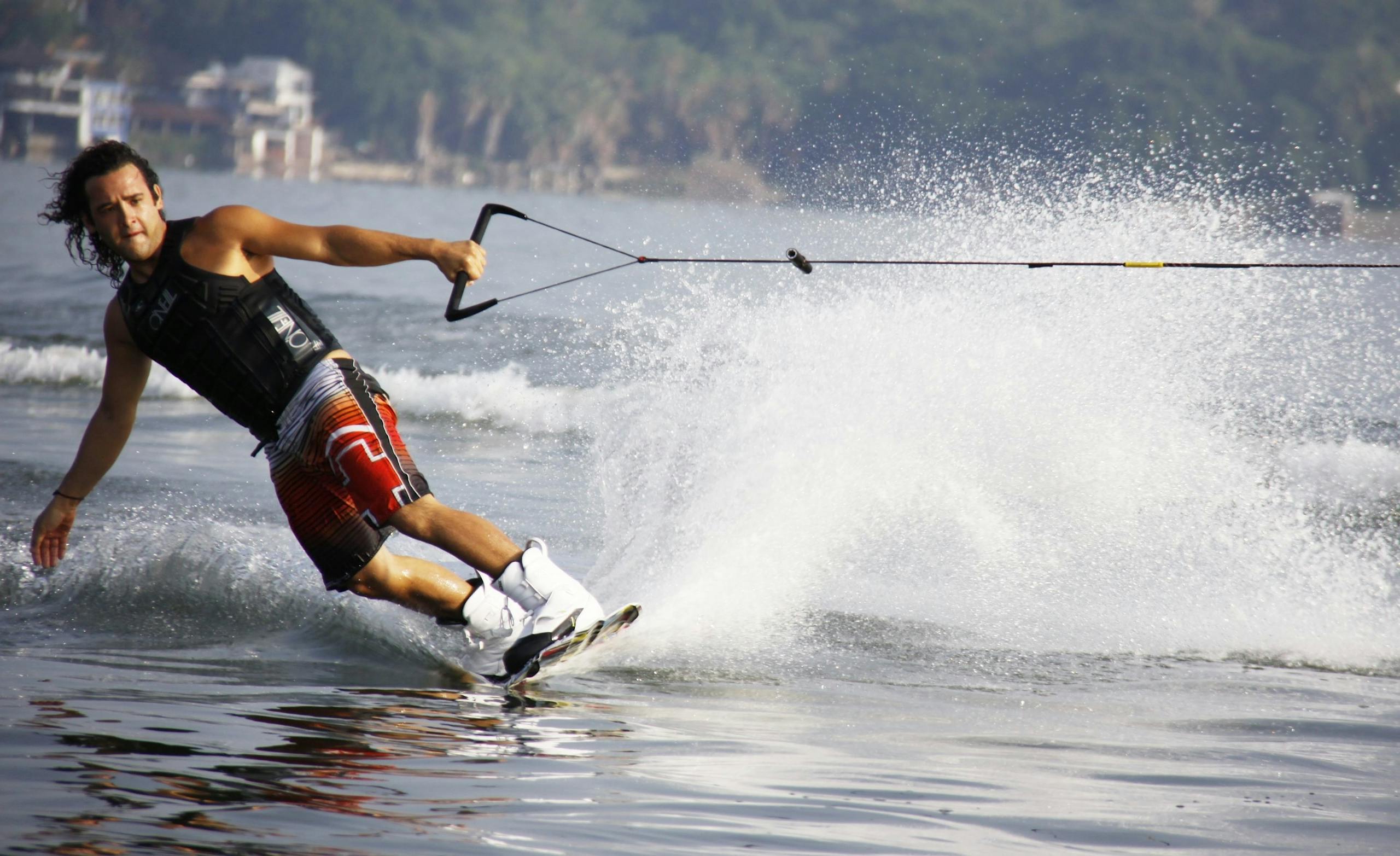 Experience the thrill of wakeboarding with this action-packed lake scene capturing a wakeboarder in motion.